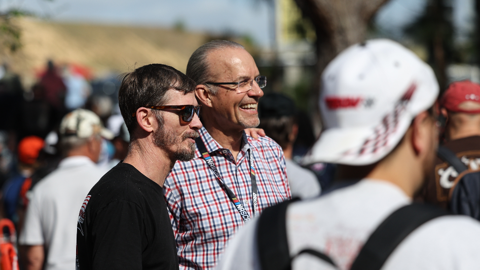 Kyle Petty greets racing fans as they arrive by train in Rockingham