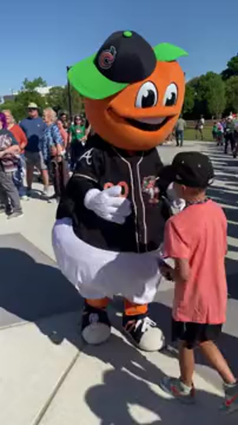 Columbus Clingstones mascot welcomes fans outside Synovus Park