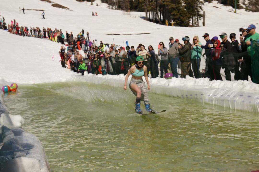 Watch skiers, snowboarders glide across a chilly pond (or wipe out trying) at Tamarack Resort