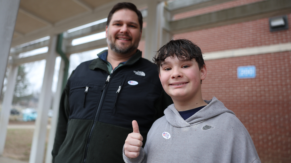 Local voter and his son participate in primary election
