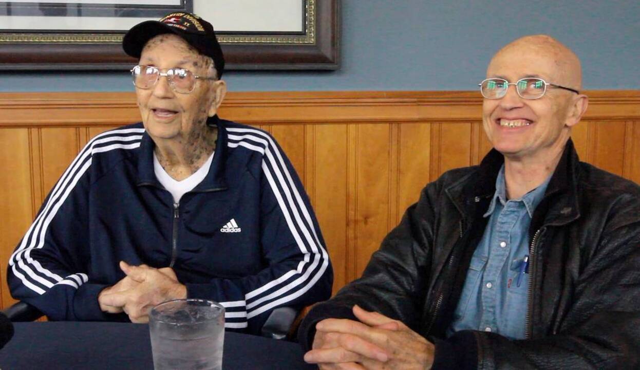 WWII veteran and son hug in emotional first meeting