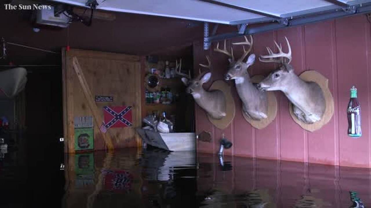 South Carolina brothers watch floodwaters encroach on family memories