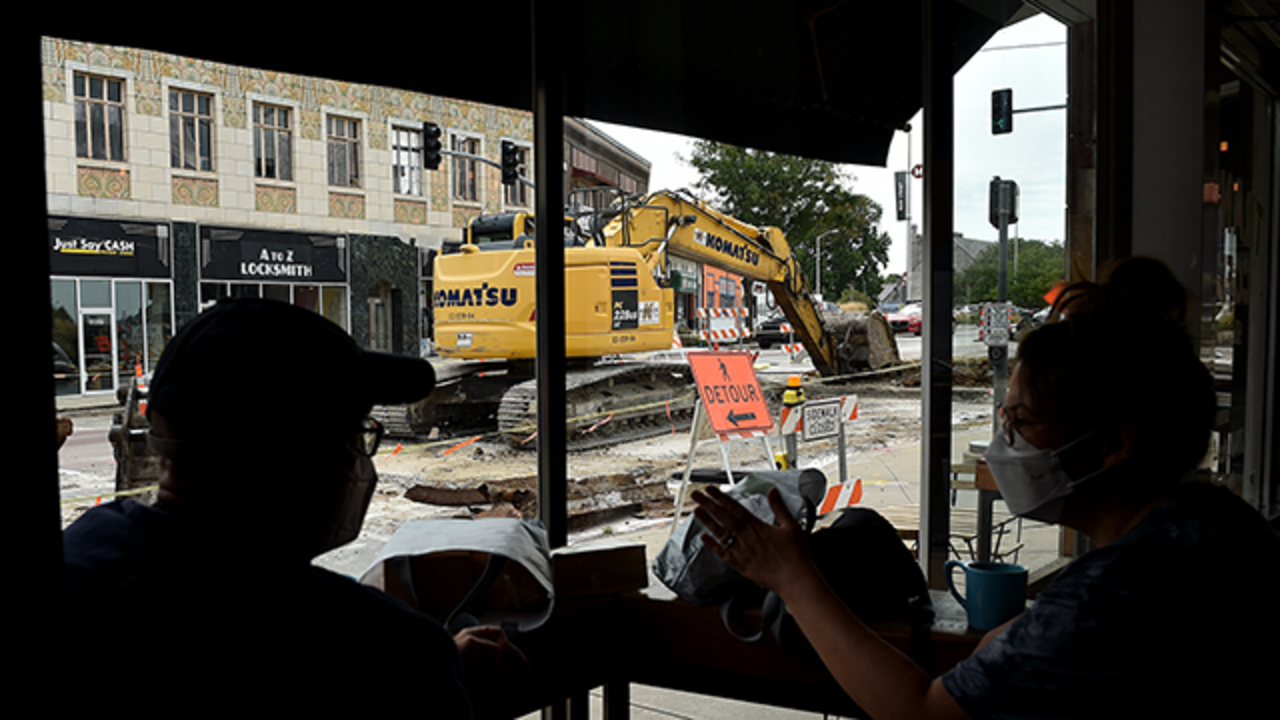 Two views on the streetcar expansion mess outside their shop windows