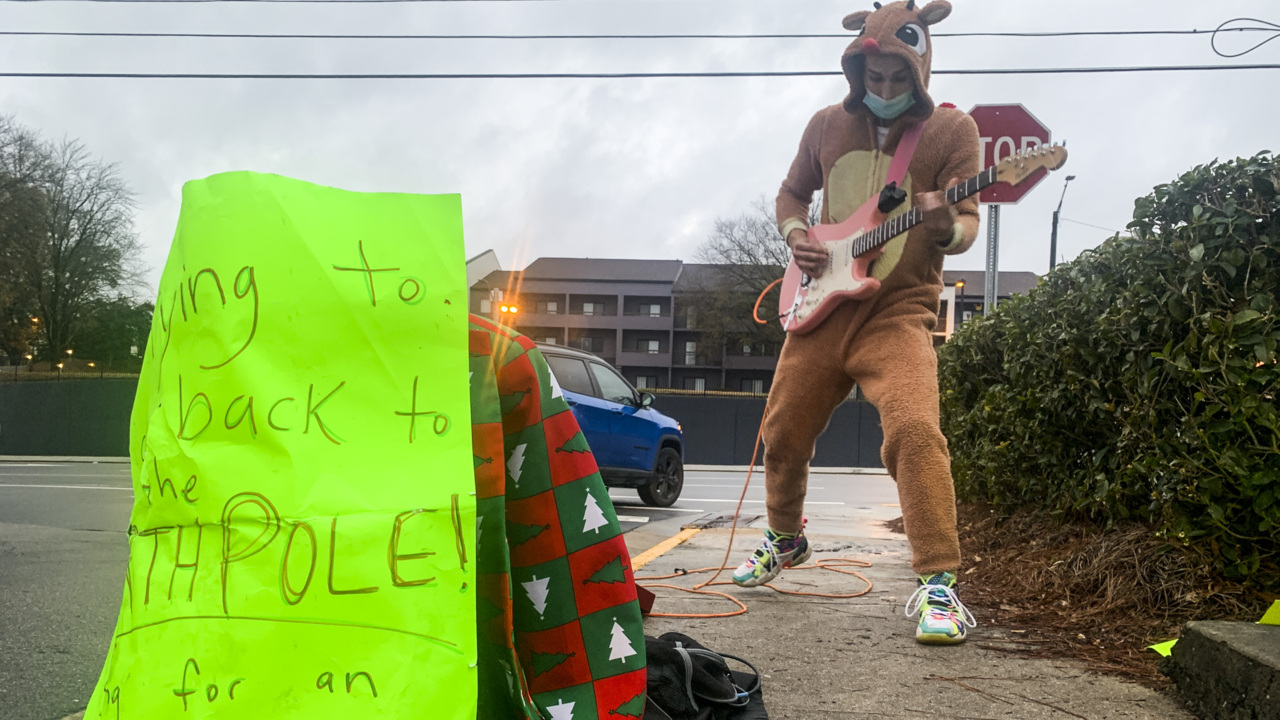Busker rocks holiday music outside Raleigh Trader Joe’s