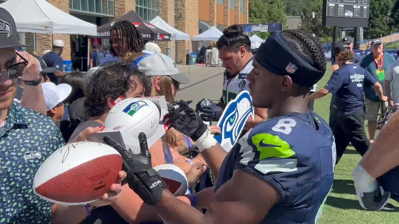 Rookie Jadarian Price signing for fans on 3rd day of Seahawks training camp