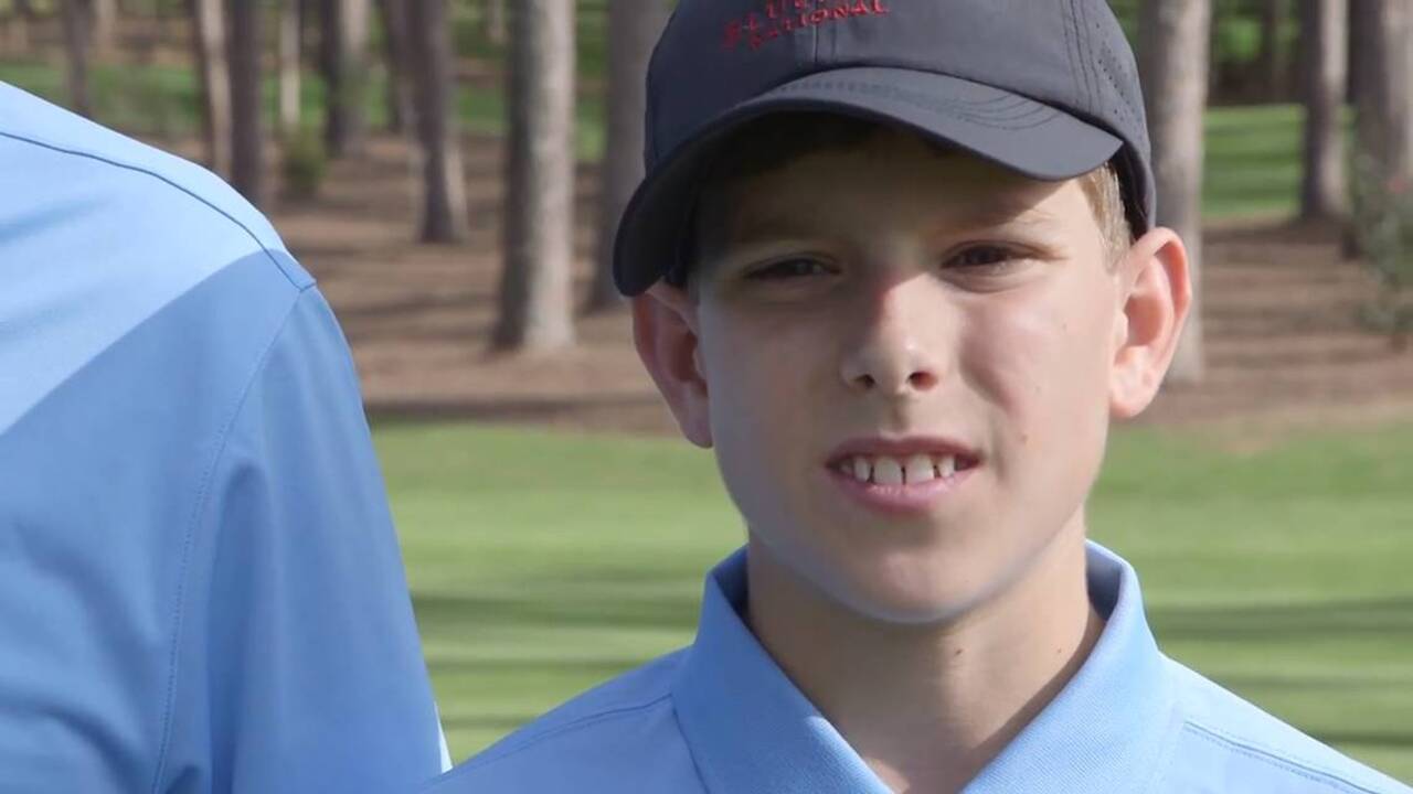Boy hits hole-in-one at golf course in front of Tiger Woods