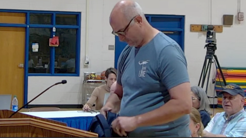 Critic of SC school board throws chicken feed in disgust for not banning more books