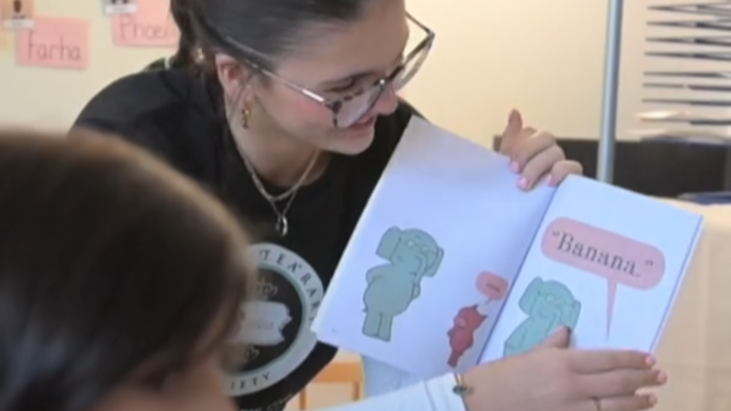 State College Key Club members read and give books to pre-K students