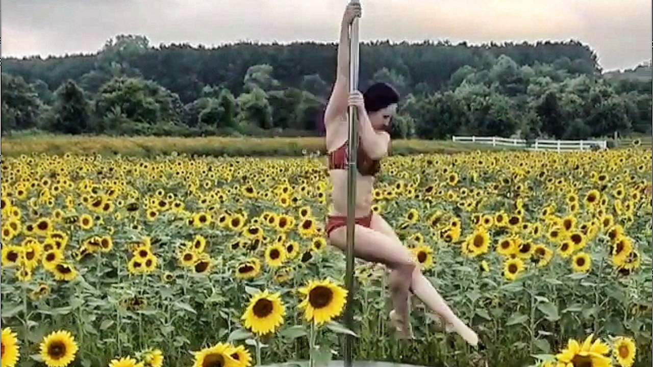 Professional pole dancer creates video in Raleigh sunflower field