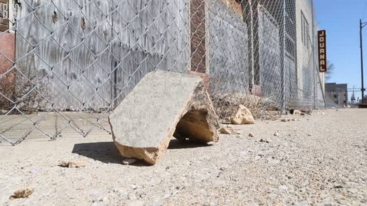 Crumbling skyscraper in heart of city threatens those below
