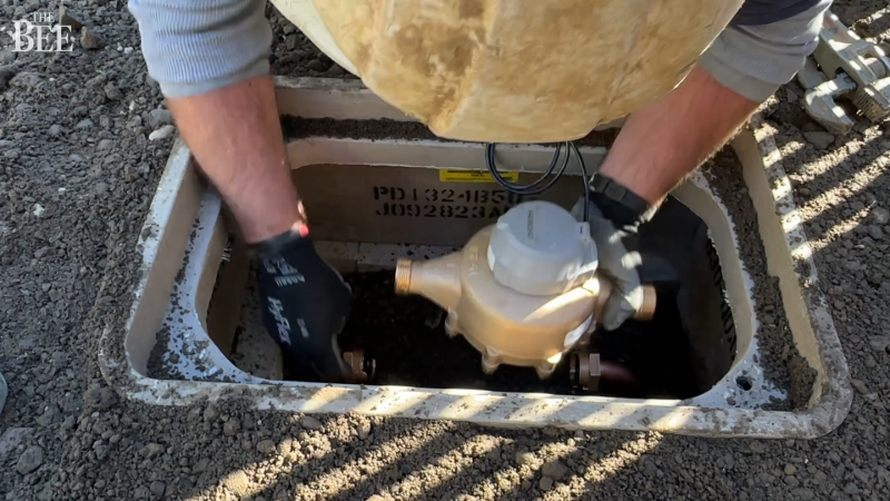 See Sacramento utility workers install one of the last water meters