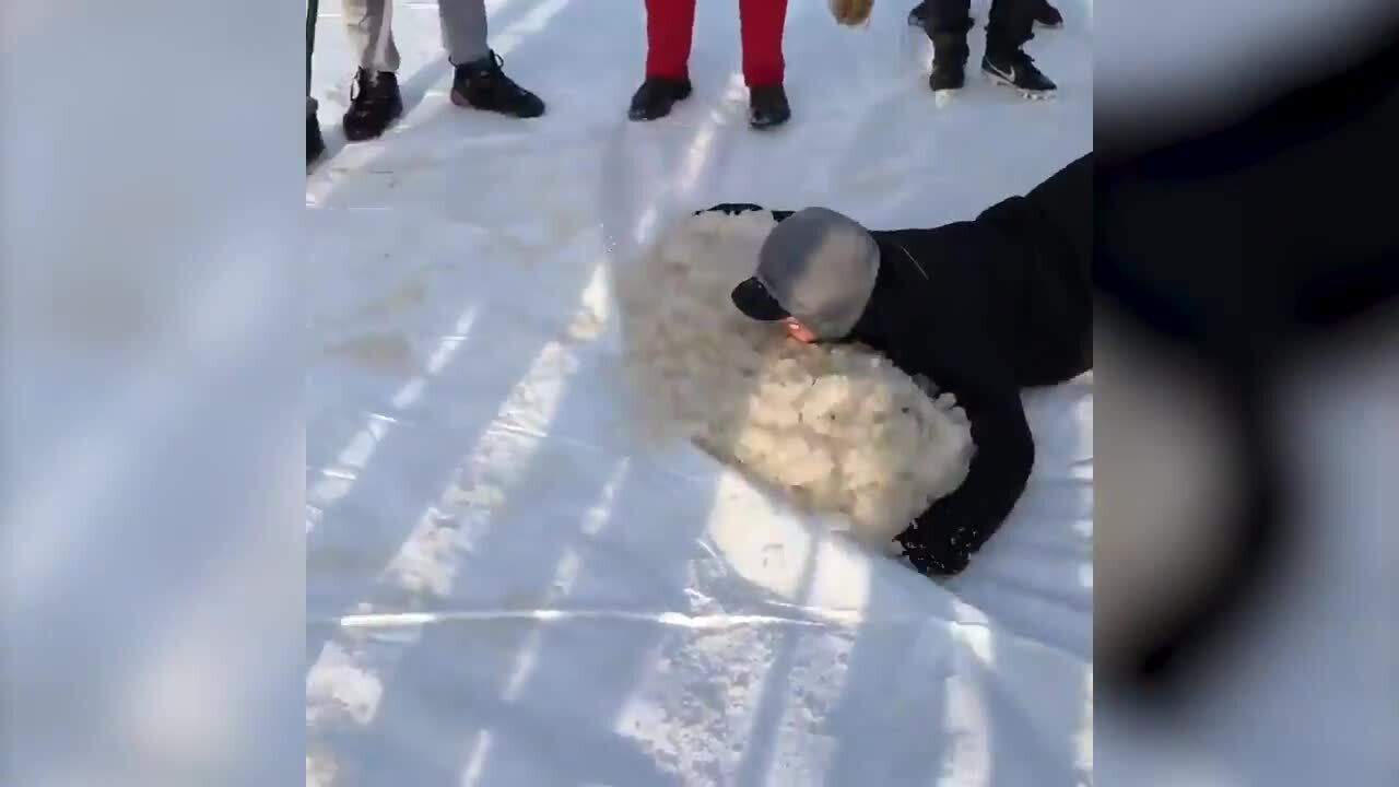 College baseball team uses human snow plow to clear field before game