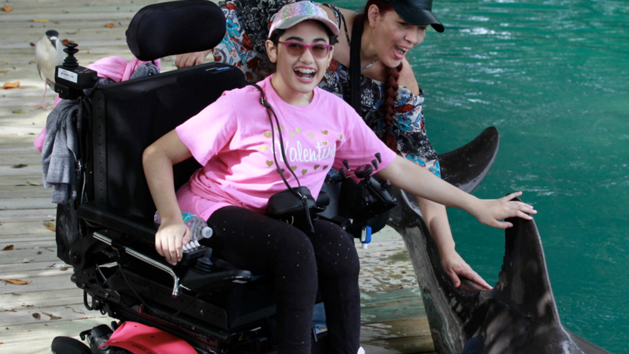 Little Havana teen with severe spina bifida visits the Miami Seaquarium
