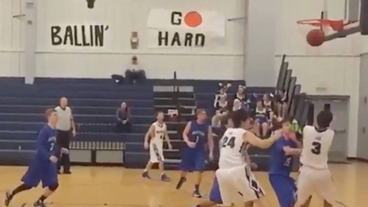 High School Basketball Player Sinks Shot Off Face