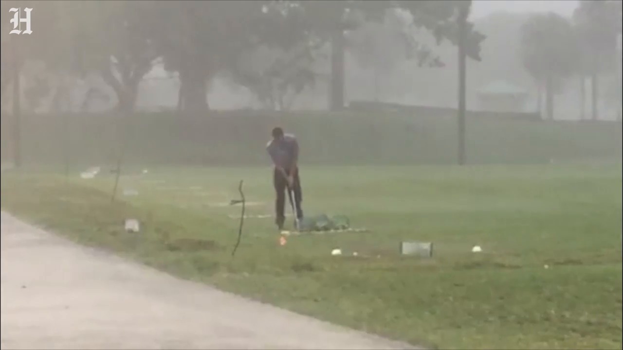Pouring rain doesn't stop golfer from driving range