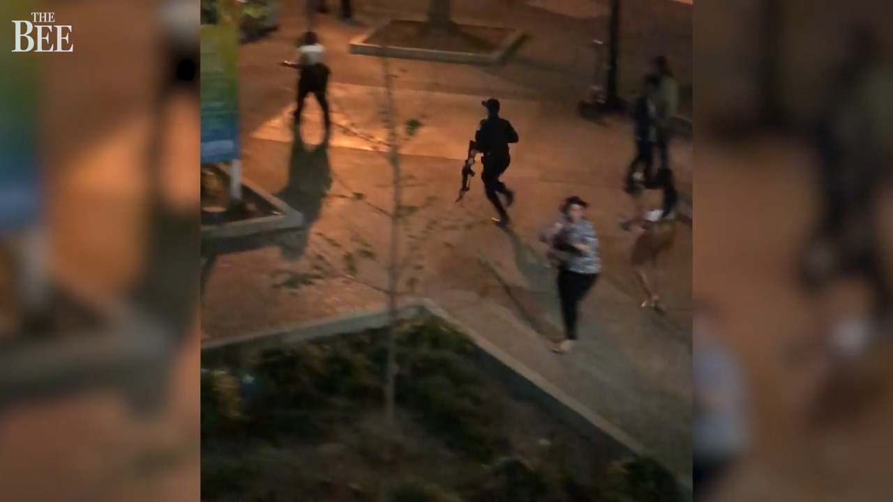 Police rush in and bystanders flee after the downtown Sacramento mass shooting