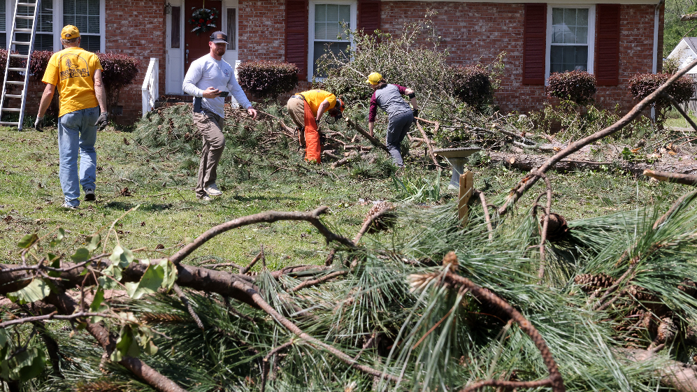 Volunteers help with cleanup, couple waits in dark for power to be restored