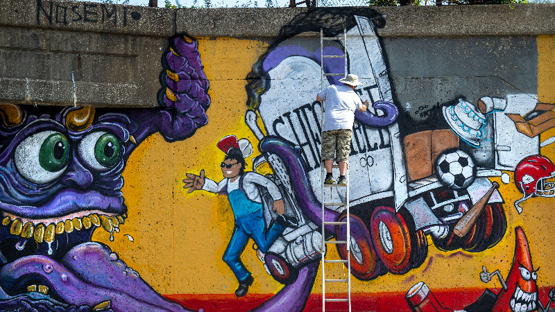 Video captures artists as they transform KC’s iconic truck-eating bridge with murals