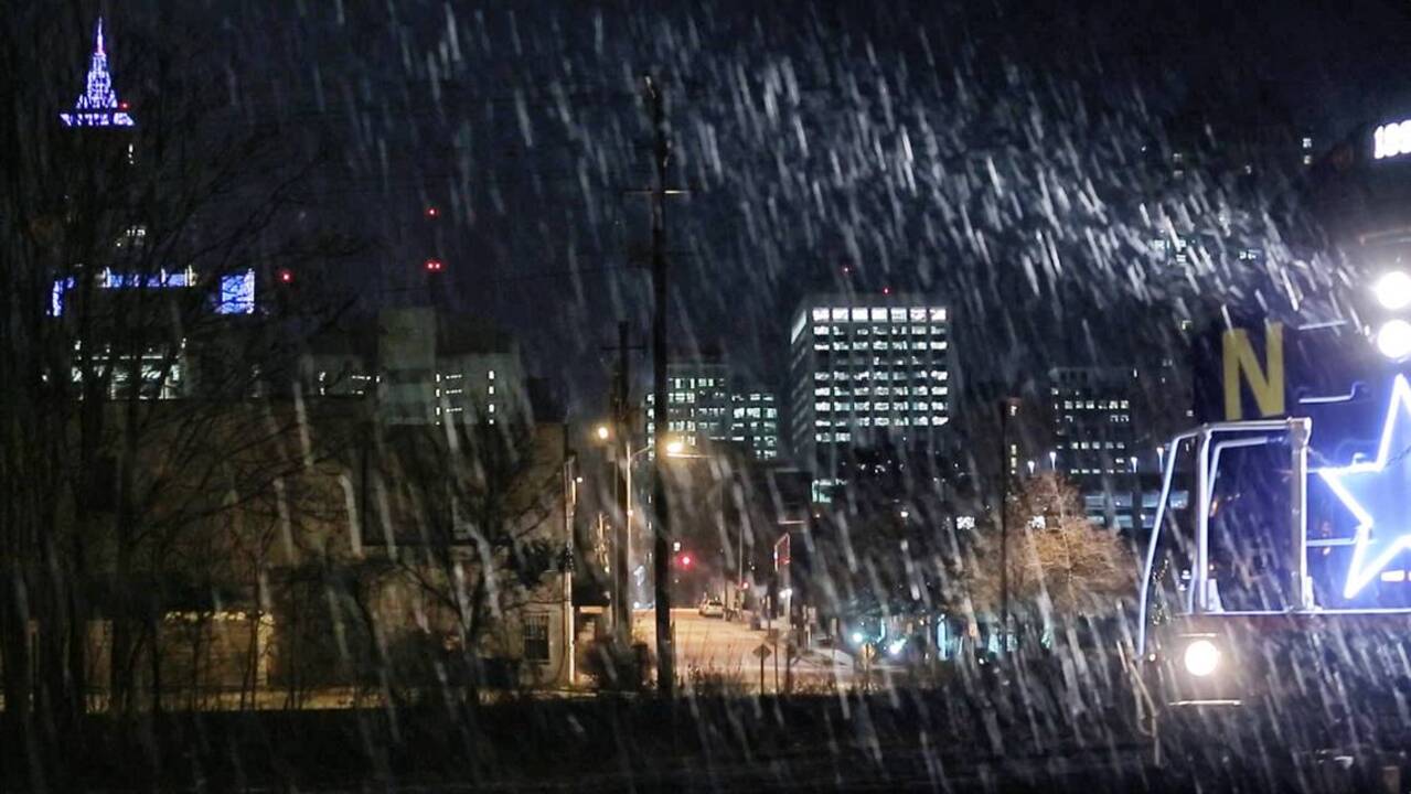 Amtrak rolls out of Raleigh in early morning snow
