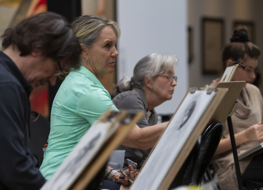 Artists, public mingle at sketch under the skylight gathering at Bo Bartlett Center