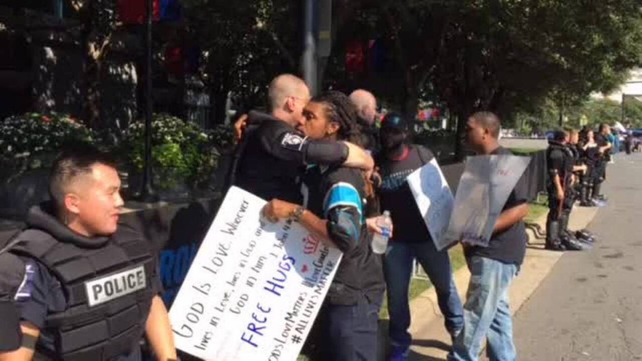 Protester hugs police officer outside Bank of America Stadium