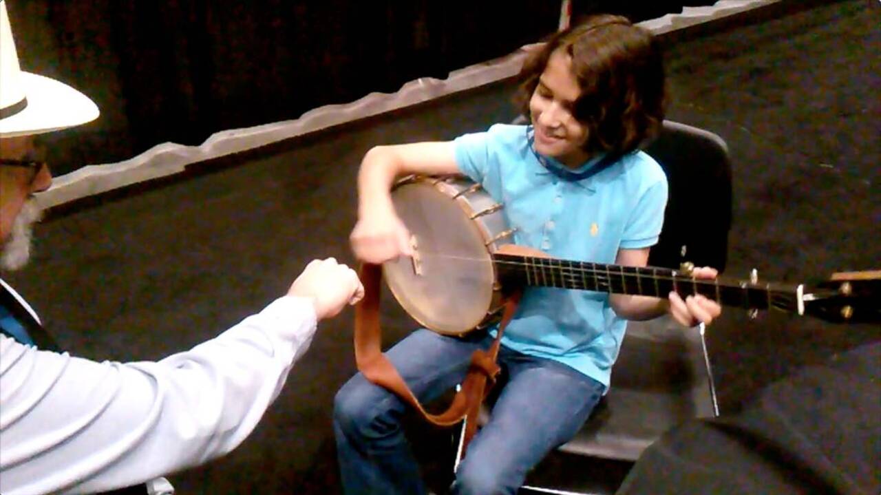 9-year-old Uma Peters playing old-time banjo at IBMA
