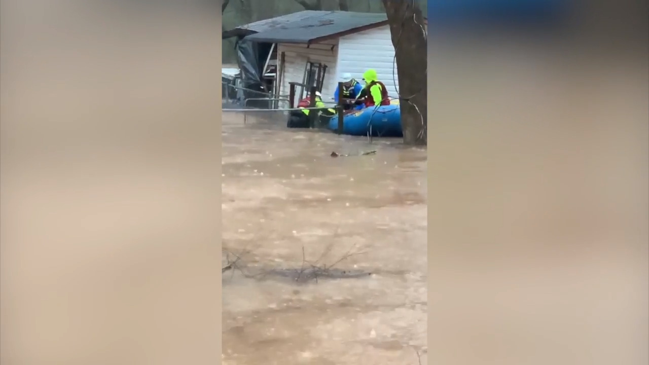 Watch rescuers wade through chest-deep flood water to save pet stuck in SC doghouse