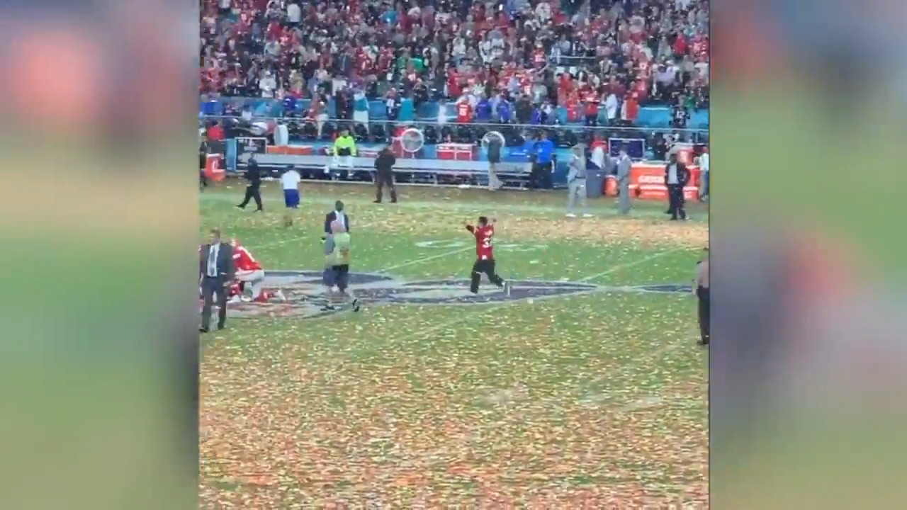 As Chiefs players celebrate, excited fan darts across field and gets leveled