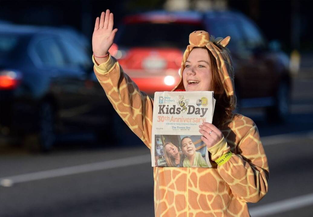 A properly attired Fresno State student sells Kids Day papers