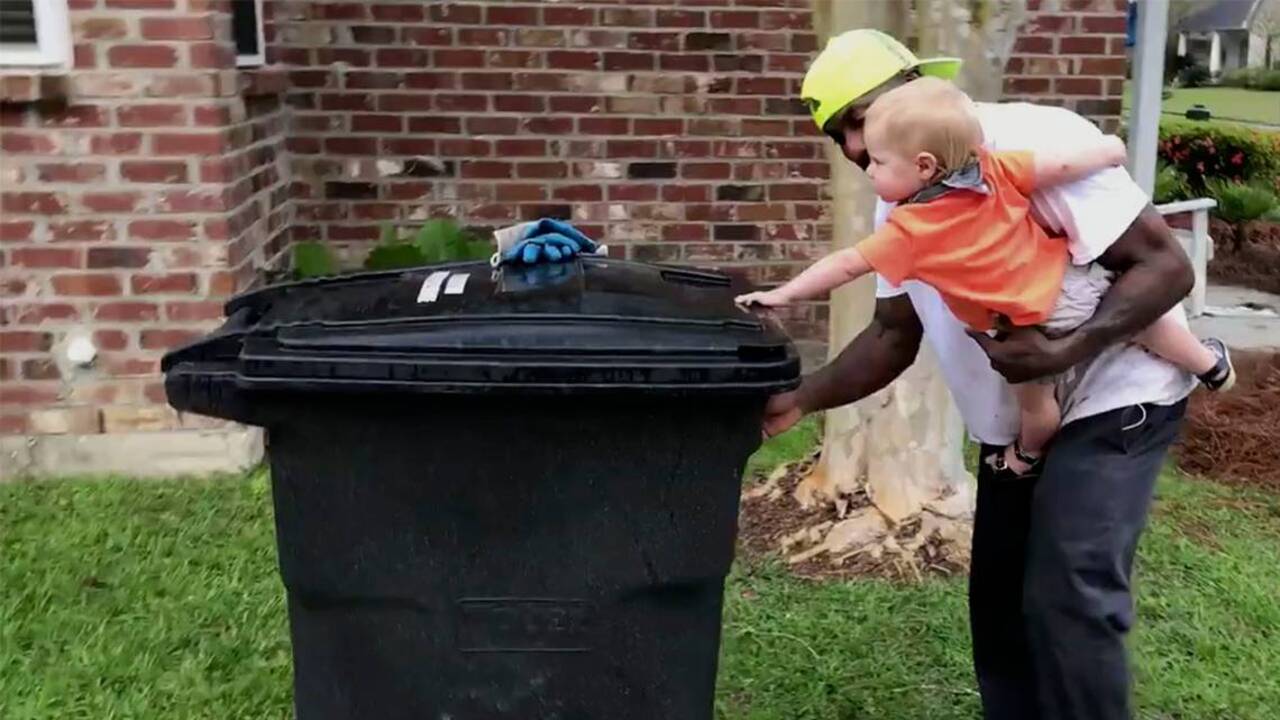 Baton Rouge toddler is garbage man's morning helper