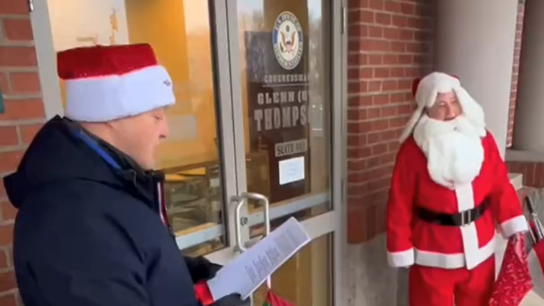 Protesters sing carols at Thompson's office after delivering coal
