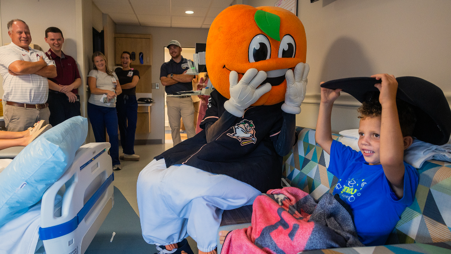 Clingstones mascot Fuzzy visits Bill and Olivia Amos Children’s Hospital