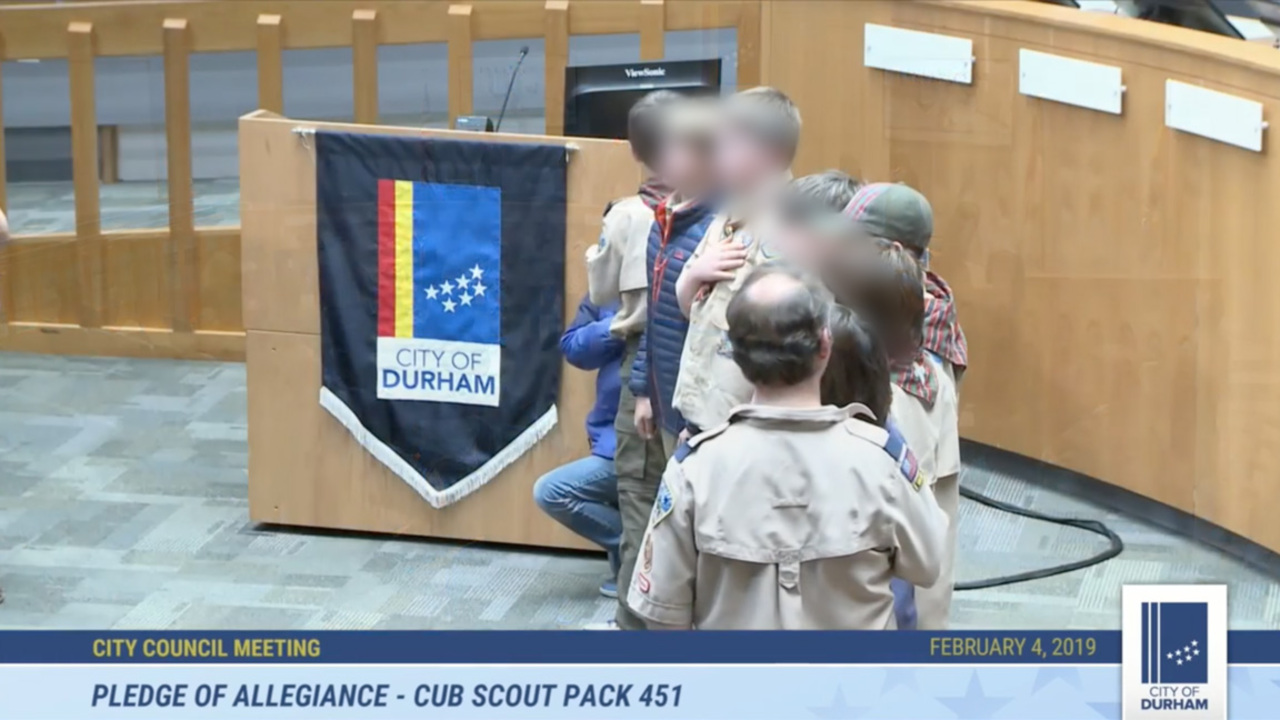 Durham Cub Scout takes a knee during Pledge of Allegiance at City Council meeting
