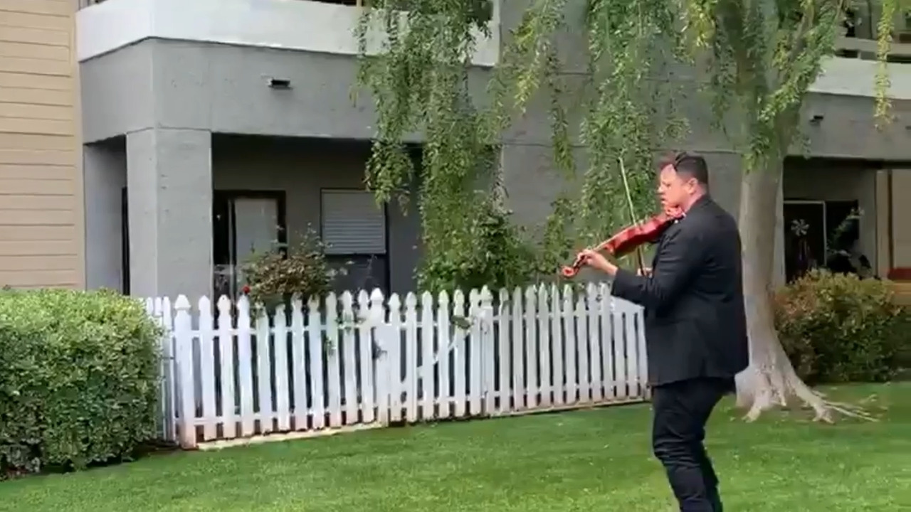 Violinist Patrick Contreras  performs sidewalk serenades