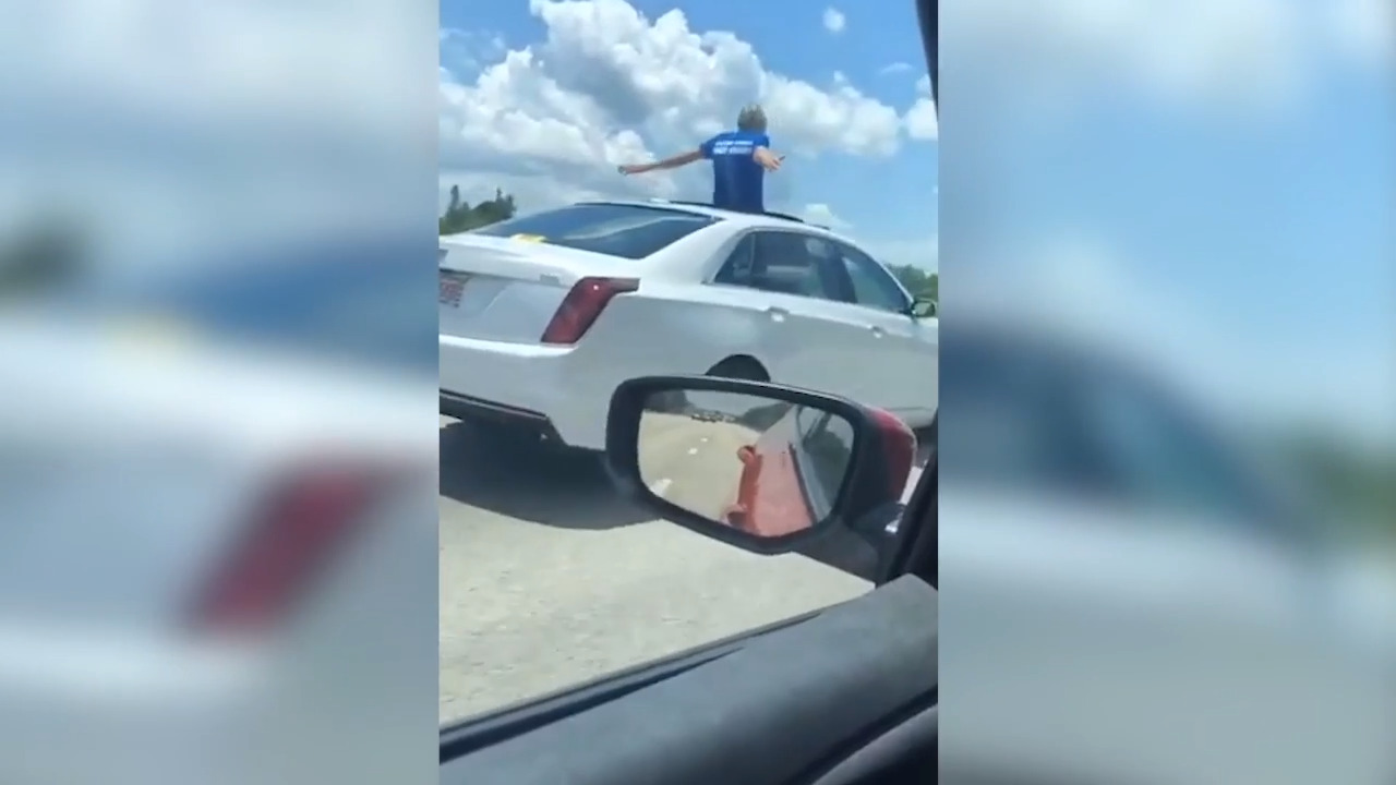 Florida man stands through sunroof while driving on interstate