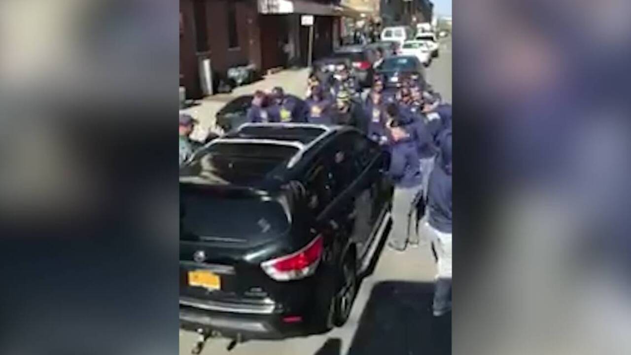 College baseball team moves double-parked car blocking bus's path