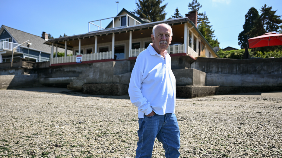 Waterfront log cabin for sale in University Place comes with a train-track walk.