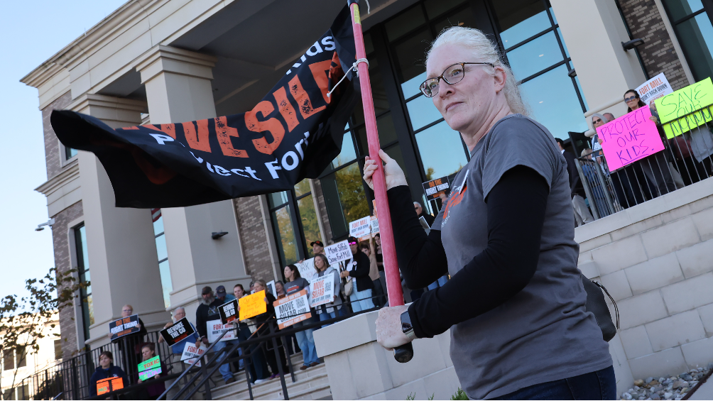 Dozens protest at county council meeting amid new lawsuits