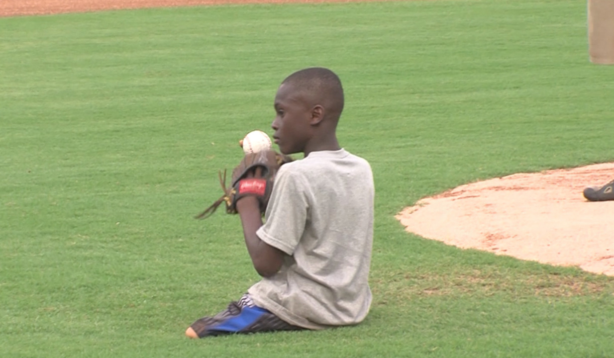 Cleveland boy without legs throws first pitch at Myrtle Beach Pelicans game