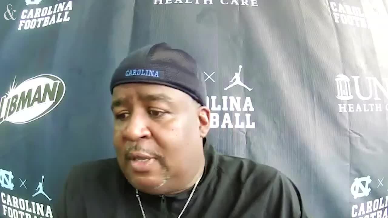 UNC defensive line coach Tim Cross hands out popsicles