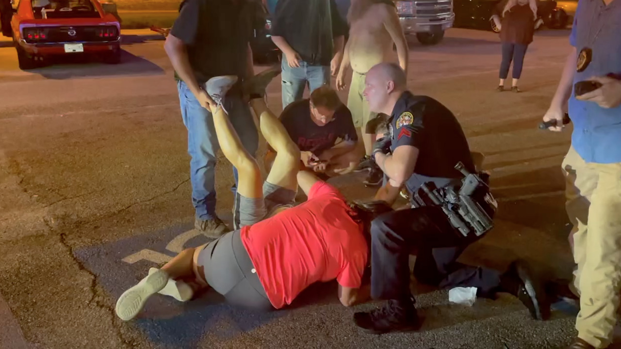 Cruisin’ The Coast spectator shot in crowd on U.S. 90 roadside in Biloxi