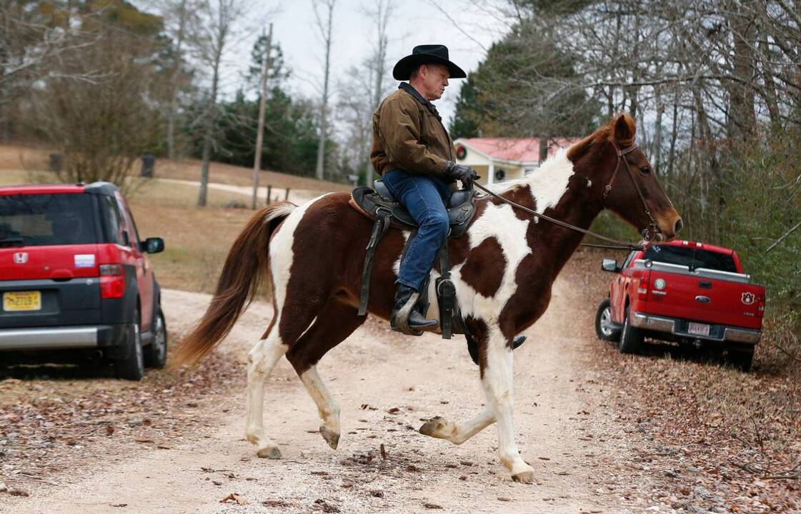 Alabama Senate candidate Roy Moore rides horse to cast ballot
