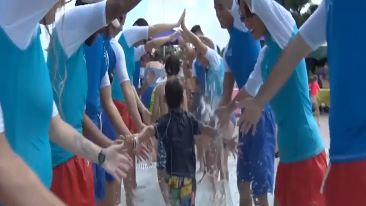 Children receive a life-saving skill at the World’s Largest Swimming Lesson