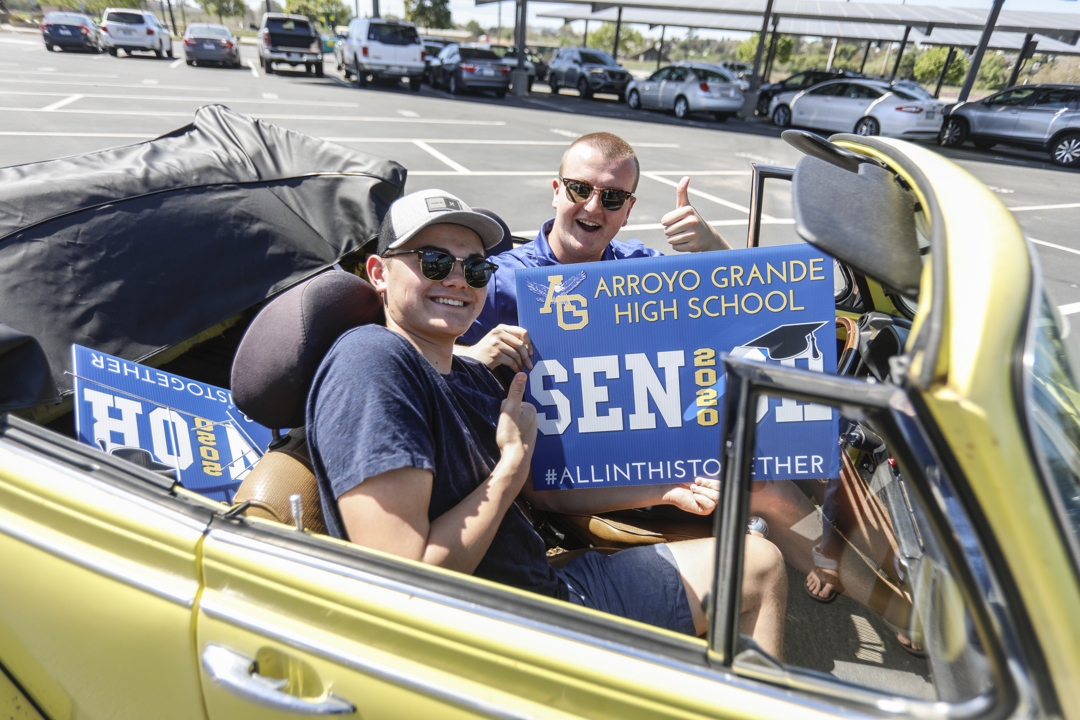 Arroyo Grande High parents and volunteers hand out signs for graduating seniors