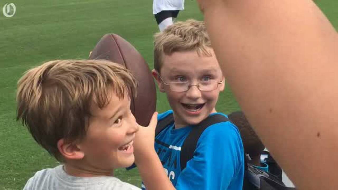 Why does Cam Newton give the ball to a child after scoring? Here’s the story.