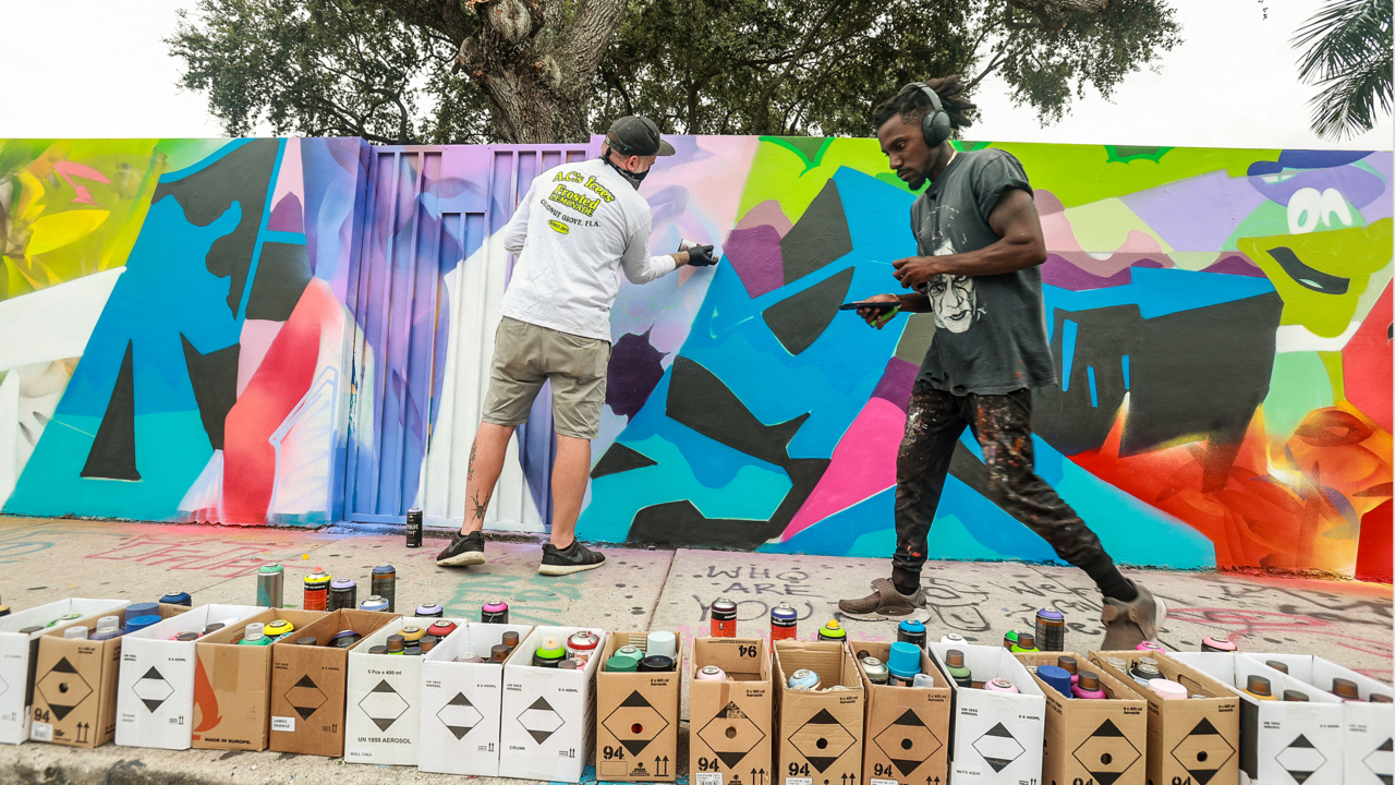 Local graffiti artists Quake and Hiero paint a mural at Wynwood Walls