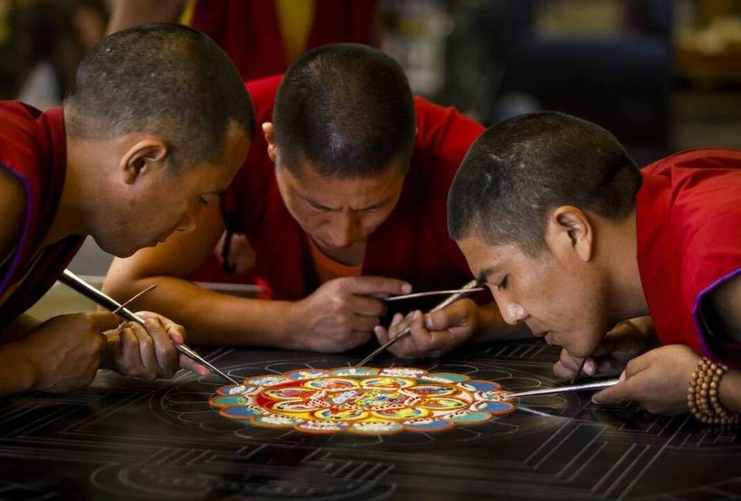 Tibetan monks creating sand mandalas at spots around SLO County
