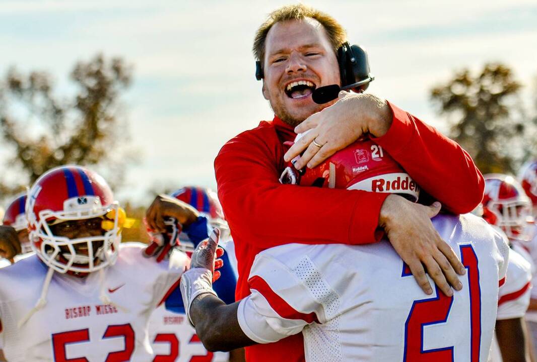 Bishop Miege football players and fans celebrate winning the state championship