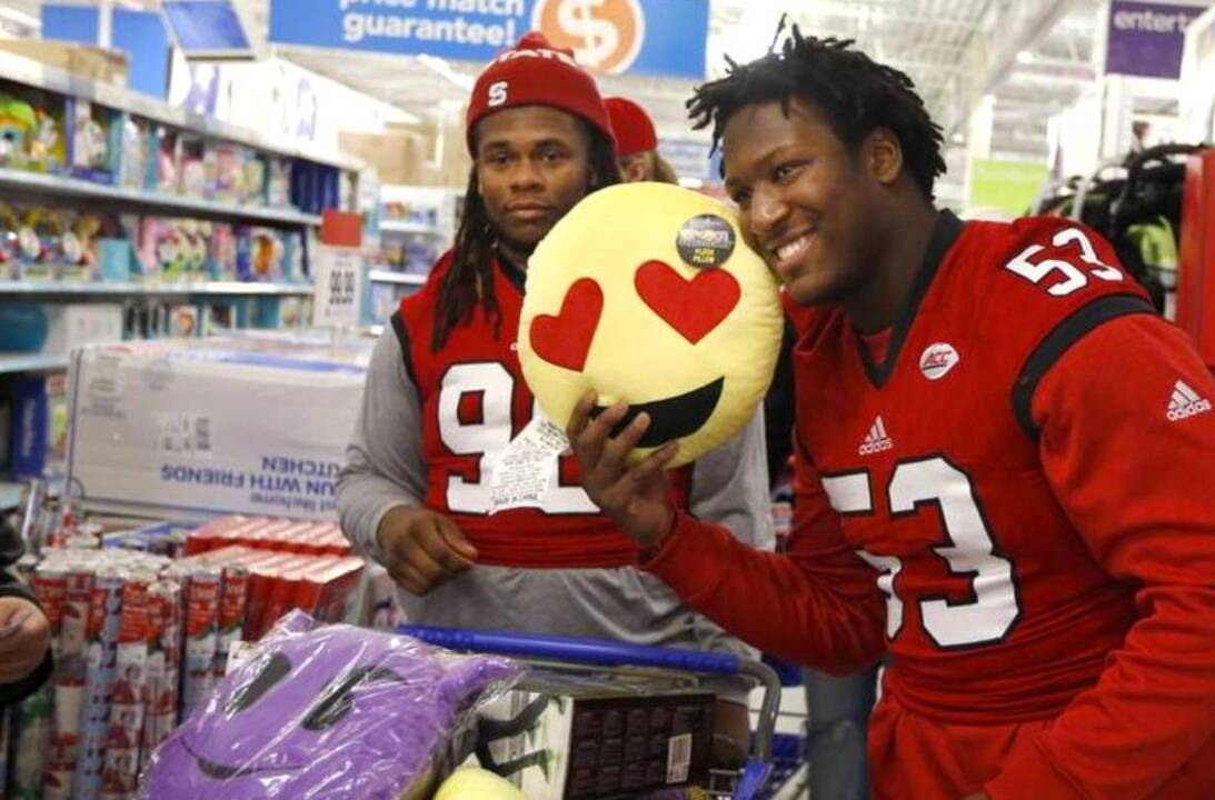 NC State football players team up with Toys for Tots