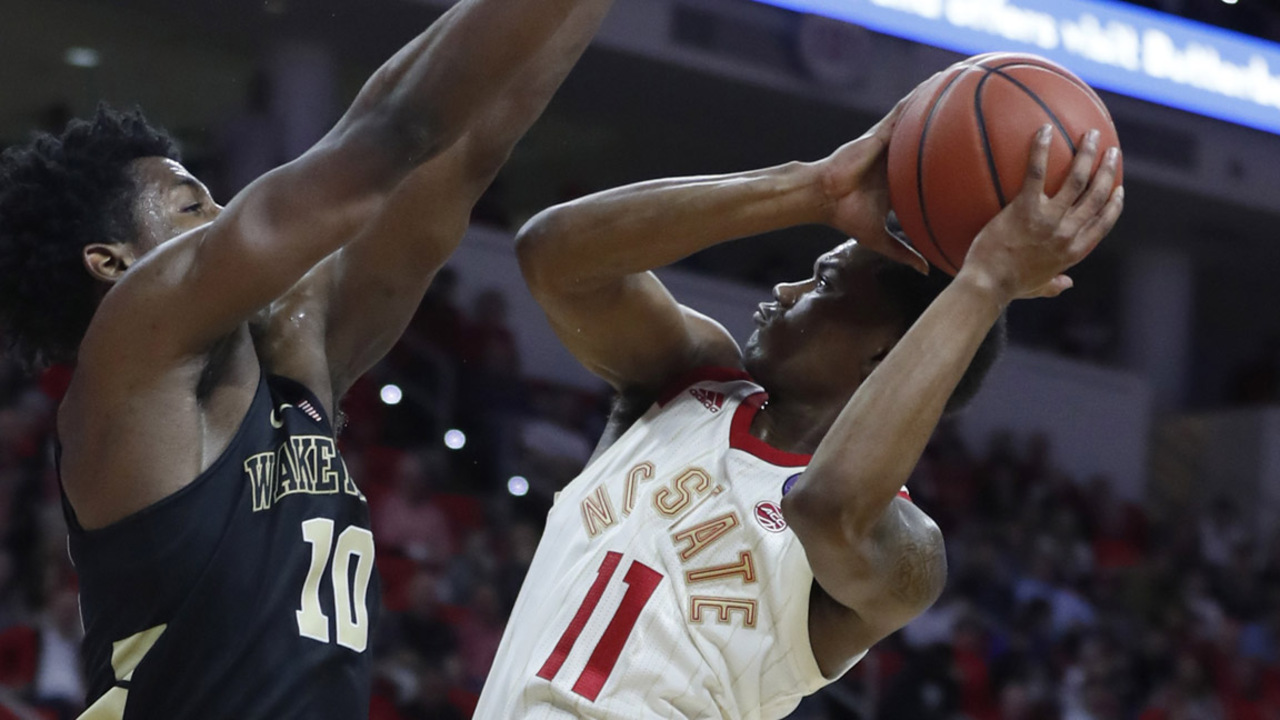 NC State and Wake Forest pass in night, headed different directions